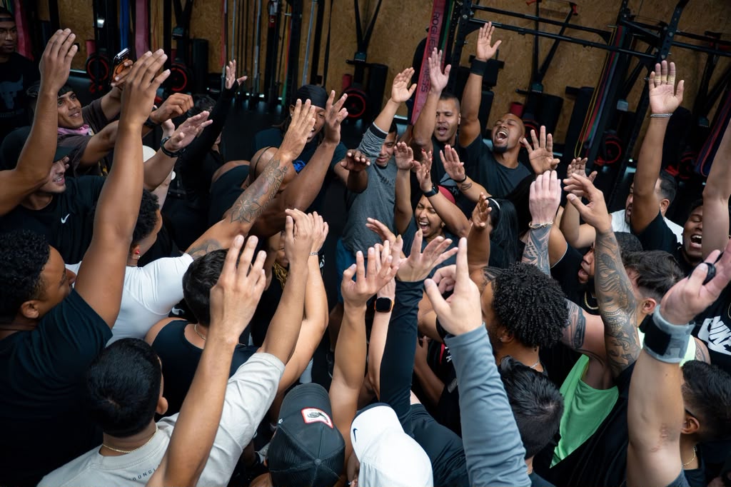The team celebrating with hands raised after the session